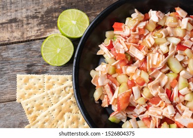 Traditional Surimi Crab Ceviche With Cucumber And Tomato On Wooden Background