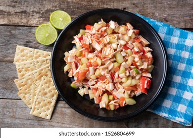 Traditional Surimi Crab Ceviche With Cucumber And Tomato On Wooden Background