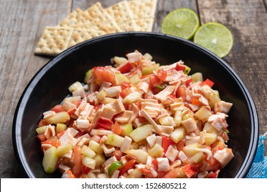 Traditional Surimi Crab Ceviche With Cucumber And Tomato On Wooden Background