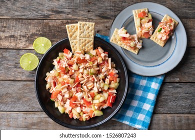 Traditional Surimi Crab Ceviche With Cucumber And Tomato On Wooden Background