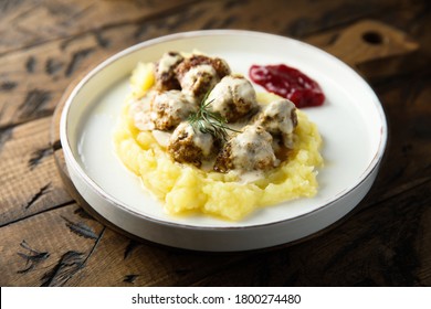 Traditional Swedish meatballs with potato and berry sauce