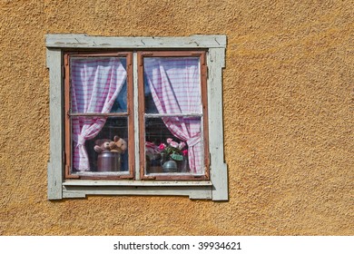Traditional Swedish Window With Gingham Curtains And Colorful Window Plants
