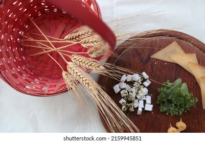 Traditional Table For Shavuot, Jewish Holiday Celebrating Wheat Harvest, With Cheese Platter, Red Wicker Basket And Wheat Stalks