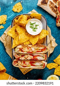 Traditional Tex Mex Dish, Supreme Nachos With Chicken Fajita, Corn Tortillas, And Sour Cream Dip On A Blue Background, Top View