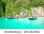 Traditional Thai boats or long tail boats against the azure water, Phi Phi Islands, Thailand