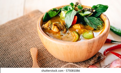 Traditional Thai food green curry and basil leave hot and spicy with chicken and meat on top able plan on wooden background wallpaper