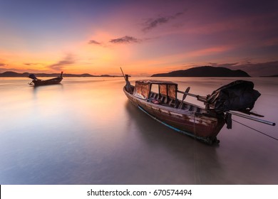 Traditional Thai long tail boat and beautiful sunrise at the sea in Phuket, Thailand
