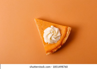 Traditional thanksgiving food on wooden table. Orange delicious homemade pumpkin pie with crust and decorative items. Thanksgiving table setting concept.Top view, close up, copy space, background.