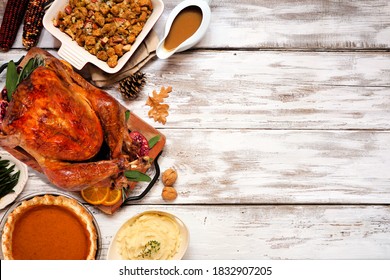 Traditional Thanksgiving Turkey Dinner. Top View Side Border On A Rustic White Wood Background With Copy Space. Turkey, Stuffing, Mashed Potatoes And Pumpkin Pie.