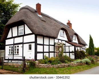 A Traditional Thatched Cottage In Rural England