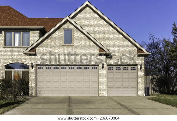 Traditional three
car wooden garage with
driveway