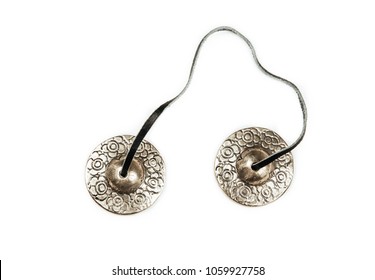 Traditional Tibetan Tingsha bells (or Ting-Sha), isolated onwhite background.  Alternative sound therapy concept, used in prayer and rituals.
