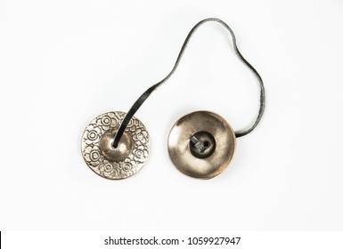 Traditional Tibetan Tingsha bells (or Ting-Sha), isolated on white background. Sound therapy concept, used in prayer and rituals. Alternative medicine concept. 