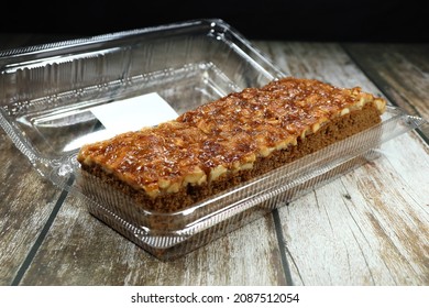 Traditional Toffee Cake Serving In The Plastic Box. Famous And Classic Mocha Sponge Cake Topping With Caramel And Macadamia Nut. 