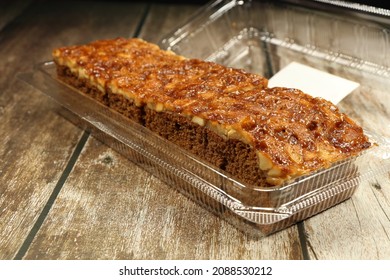 Traditional Toffee Cake Serving In The Plastic Box. Famous And Classic Mocha Sponge Cake Topping With Caramel And Macadamia Nut. 