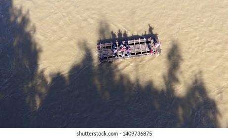 A Traditional Transportation With Wooden Raft Crossing The River View From Above With Aerial Drone