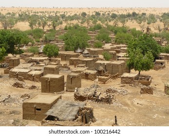 Traditional tribal village with flat-roofed mud dwellings and granaries in the West African nation of Mali.