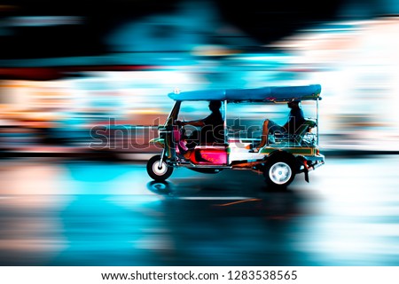 Traditional tuk-tuk from Bangkok, Thailand, at night in motion blur. This is a car that use to transport people for a long time and now this is a car that tourist should try when come to Thailand.