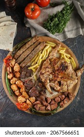 Traditional Turkish Arabic Food MIx Barbecue Grilled Lamb, Shish Kabab, Chicken, Lamb, Chops French Fries, Tomato On Dark Background. Top View