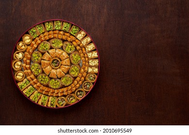 Traditional turkish, arabic sweets baklava assortment with pistachio and cashew. Top view, copy space	                               - Shutterstock ID 2010695549