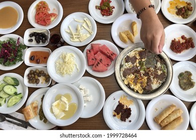 Traditional Turkish Breakfast. Hand Holding Fork. Lots Of Plates With Food Top Down View