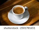 Traditional Turkish coffee cup placed on a wooden table