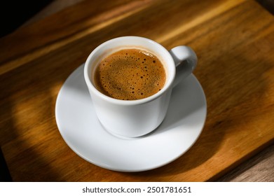 Traditional Turkish coffee cup placed on a wooden table - Powered by Shutterstock