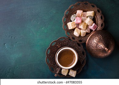 Traditional turkish coffee  and turkish delight on dark green wooden background. Flat lay. - Shutterstock ID 697083355