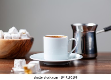 Traditional Turkish coffee served in classical cups with Turkish delights. A metal coffee pot is in the background. - Powered by Shutterstock