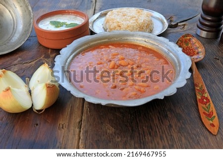 Traditional Turkish cuisine. Kuru Fasulye . Haricot Beans, rice and beans (Turkish name; pilavli kuru fasulye) under the rustic wood etli kuru fasulye