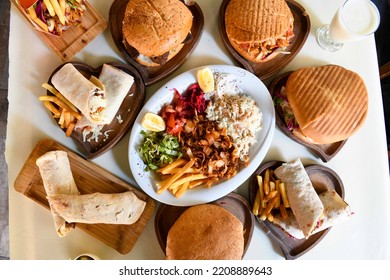 Traditional Turkish cuisine. Pizza, pita, pidesi, sucuk, hummus, kebab. Many dishes on the table. Serving dishes in restaurant. Background image. Top view, flat lay - Shutterstock ID 2208889643