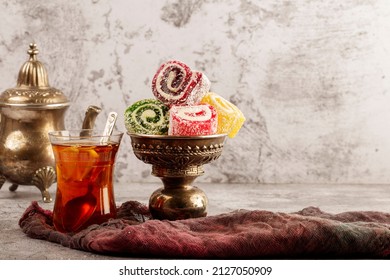Traditional Turkish delight with Turkish tea on gray background. Ramadan Kareem celebration concept. Fragrant Turkish tea and Turkish sweets in national dishes. - Powered by Shutterstock