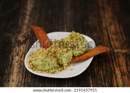 Traditional Turkish and Greek appetizer (meze) Greek or Cretan meze made with Basil, feta cheese, garlic and olive oil. Girit Ezme appetizer on a white plate on wooden background.  Stok fotoğraf © 