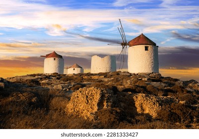 Traditional typical  greek windmills. Amorgos island in Cyclades, Chora village over sunset - Shutterstock ID 2281333427