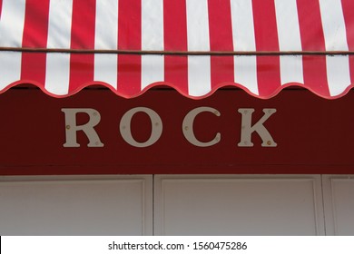 Traditional Typical Red And White Sun Awning Over Sign ROCK At British Seaside