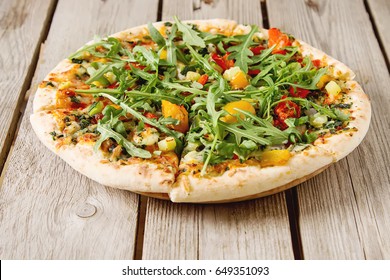 Traditional vegetarian Italian pizza with cheese, arugula, pepper and tomatoes. Fast food. Not a diet. Light background - Powered by Shutterstock