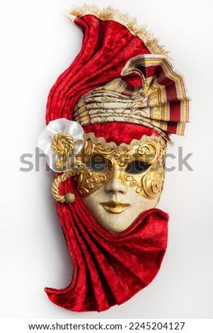 Traditional Venetian mask with red and gold decor isolated on white background. Mask for carnival of Venice.