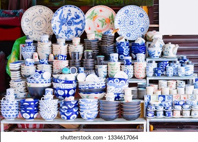 Traditional Vietnamese blue porcelain utensils with plates and cups and bowls on dispay at street market in Hoi An old city in Southeast Asia in Vietnam. Handmade souvenirs of crockery and tableware.