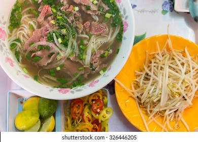 Traditional Vietnamese pho noodle soup with rare beef, tendon and tripe served with onions and cilantro.