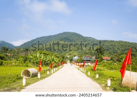 A traditional village entrance with flags , in Asia, Vietnam, Tonkin, between Dien Bien Phu and Lai Chau, in summer on a sunny day.
