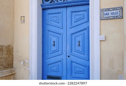 Traditional vintage painted wooden door and windows with vintage blinds in Malta. Entrance to house. Exterior of typical houses on the Mediterranean island of Malta. Popular travel destination.  - Shutterstock ID 2282247897
