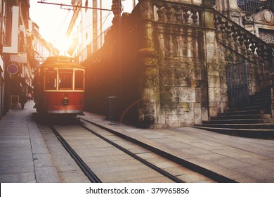 Traditional vintage tram makes its way across central streets in old city in sunny morning, public transport on metallic rails standing near architectural monument, electrical streetcar in urban scene