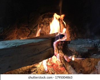 Traditional way of making food by using fire wood as bio fuel on open fire in old kitchen in a village. Rural kitchen using bio wood fuel for cooking.