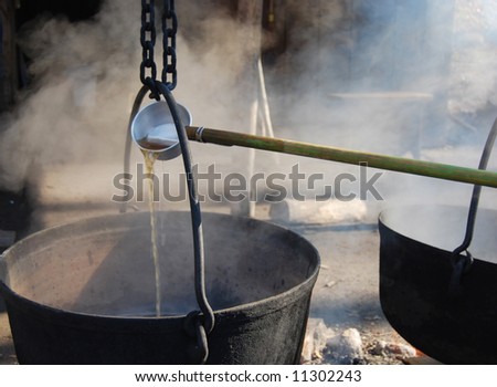 Traditional way of making maple syrup by boiling the sap in a cauldron