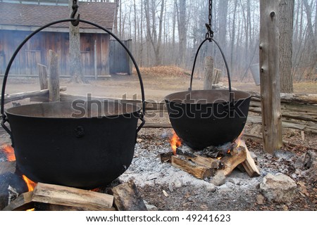 Traditional way of making maple syrup by boiling the sap in a cauldron  at sugar shack