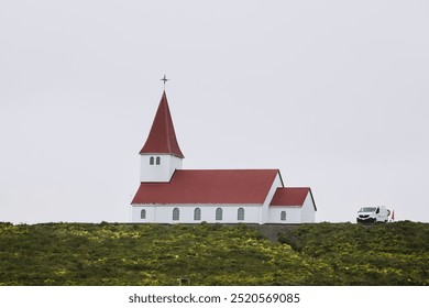 traditional white church with red roof on a hill in Iceland - Powered by Shutterstock