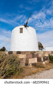 Traditional White Windmill Under Blue Sky On Milos Island. Cyclades, Greece.