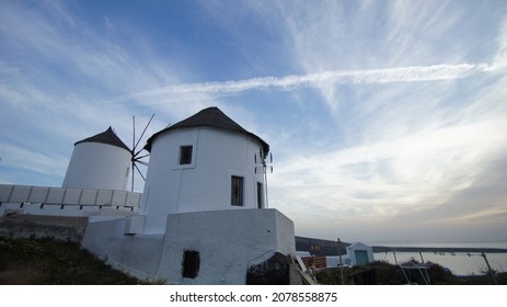 A Traditional Windmill With Blue Sly