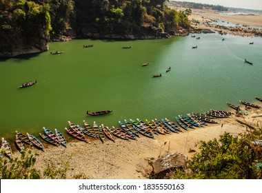 traditional wood fishing boats in many colors with lake transparent water image is taken at dwaki lake meghalya india. it is showing the pristine beauty of north east india.