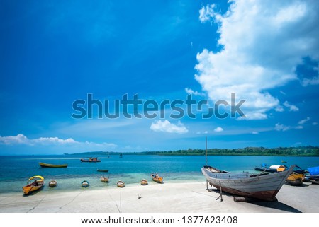 Traditional wooden boats parked at seashore white sand beach of Havelock Island, Andaman and Nicobar Islands Union Territory of India.